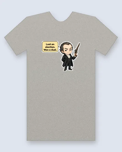 Aaron Burr tee mockup: Aaron Burr with dark swept-back hair and a sly smirk, in a black coat and white cravat, holding up a flintlock pistol, saying “Lost an election. Won a duel.”