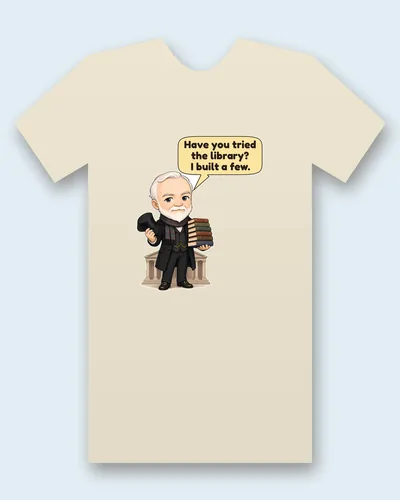 Andrew Carnegie tee mockup: Andrew Carnegie with white hair and a neat white beard, in a black frock coat and plaid scarf, holding his top hat and a tall stack of books in front of a columned library, saying “Have you tried the library? I built a few.”