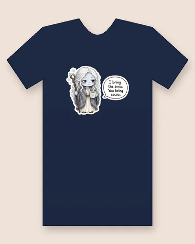 Cailleach tee mockup: The Cailleach with pale blue skin and long white hair, a grey plaid fringed shawl over a cream dress, holding a twisted wooden staff topped with snow and a steaming mug with a snowflake, with snowflakes around her, saying “I bring the snow. You bring cocoa.”