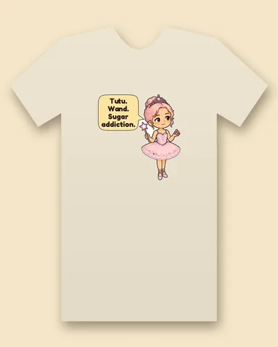Christmas Dance Fairy tee mockup: A chibi dance fairy with pink hair in a tiara and a pink tutu, holding a star wand and a handful of candy, with a speech bubble beside her, saying “Tutu. Wand. Sugar addiction.”