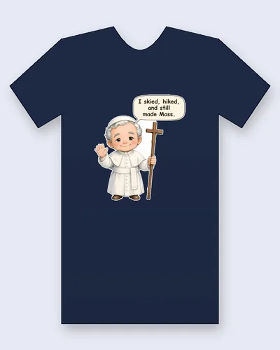Saint John Paul II tee mockup: Saint John Paul II in a white cassock with a short shoulder cape, a white sash and a white skullcap, waving hello and holding a tall wooden cross staff, saying “I skied, hiked, and still made Mass.”