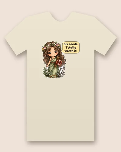 Persephone tee mockup: A girl with long brown hair and a flower crown in a green gown, holding a split pomegranate and a sheaf of wheat, with a speech bubble beside her