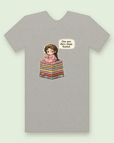 Princess and the Pea tee mockup: a tired princess with dark-ringed eyes, a gold crown and a long braid, in a rumpled pink nightgown, sitting on a tall stack of patchwork mattresses and holding one green pea, saying “One pea. Zero sleep. Ruined.”