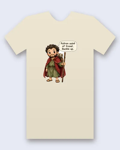 Saint Christopher tee mockup: Saint Christopher with curly hair and a beard, in a red cloak and green tunic, with a bedroll on his back and a tall walking staff, saying “Patron saint of travel. Buckle up.”