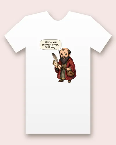 Saint Paul the Apostle tee mockup: a bald apostle with a long dark beard and a deep red cloak, carrying a feather quill, rolled scrolls and a leather satchel, saying “Wrote you another letter. Still long.”