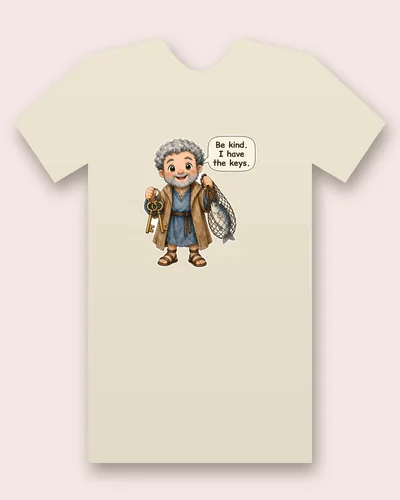 Saint Peter the Apostle tee mockup: a smiling apostle with curly grey hair and a grey beard, in a tan cloak over a blue tunic and sandals, holding two golden keys and a fishing net with a fish inside, saying “Be kind. I have the keys.”