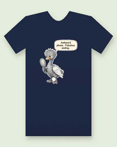 Ugly Duckling tee mockup: a scruffy grey cygnet with spiky feathers, long legs and one white, swan-like wing, peering into a hand mirror, saying “Awkward phase. Fabulous ending.”